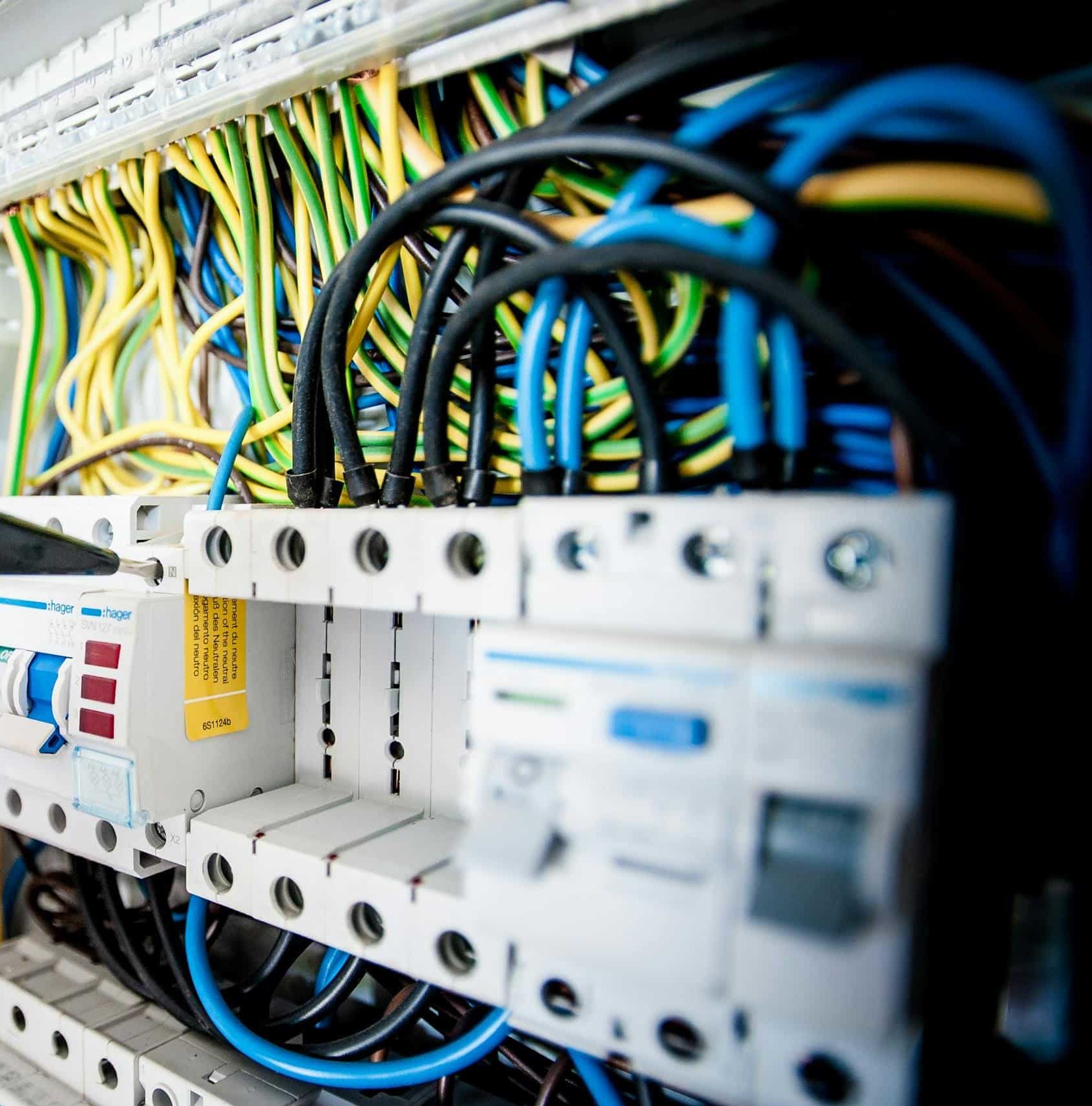 Electrician Fixing an Opened Switchboard